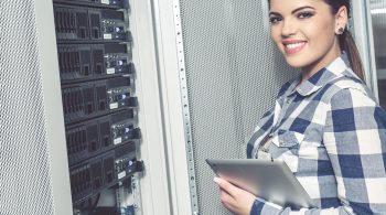 Woman technician working on servers in server room